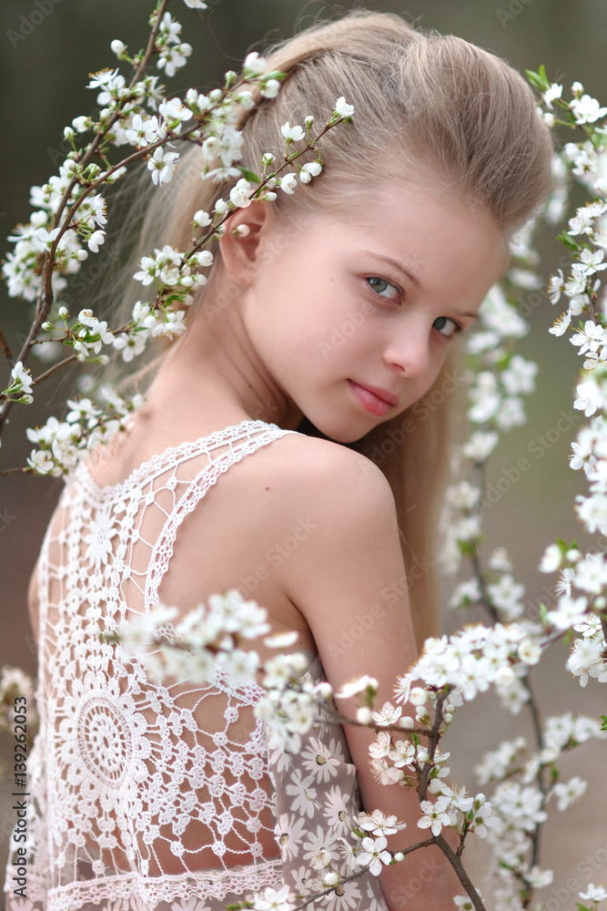 portrait of little girl outdoors in spring;