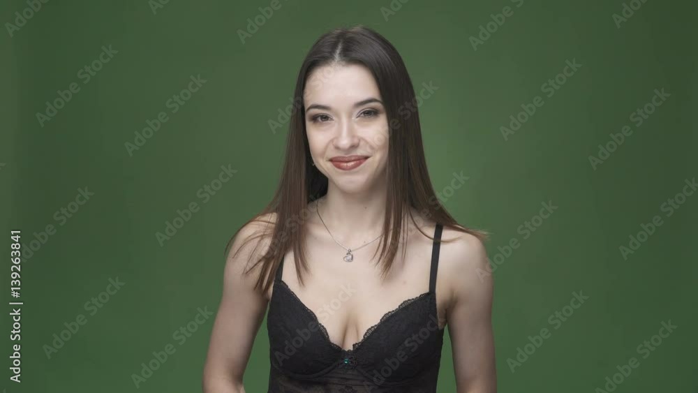 Young happy woman in black underwear smiling against chroma key green screen background Young happy woman in black underwear smiling against chroma key green screen background