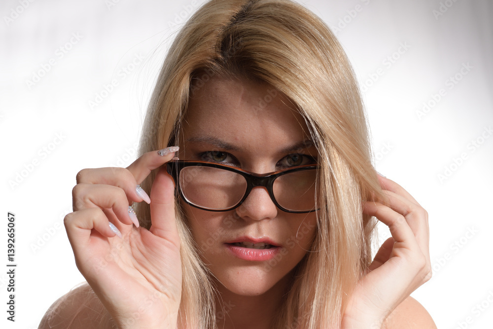 beautiful blond businesswoman with glasses and intense piercing look beautiful blond businesswoman with glasses and intense piercing look