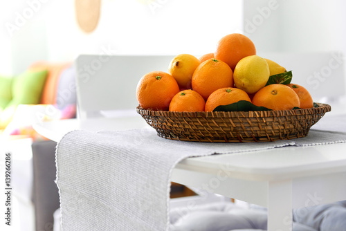 Fototapeta Naklejka Na Ścianę i Meble -  Lemons and mandarin orange fruits on a wicked plate