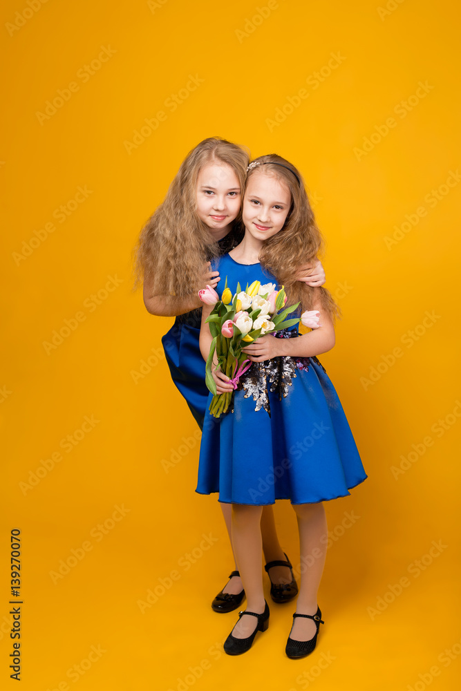 Two beautiful young girl with a bouquet of flowers Two beautiful young girl with a bouquet of flowers