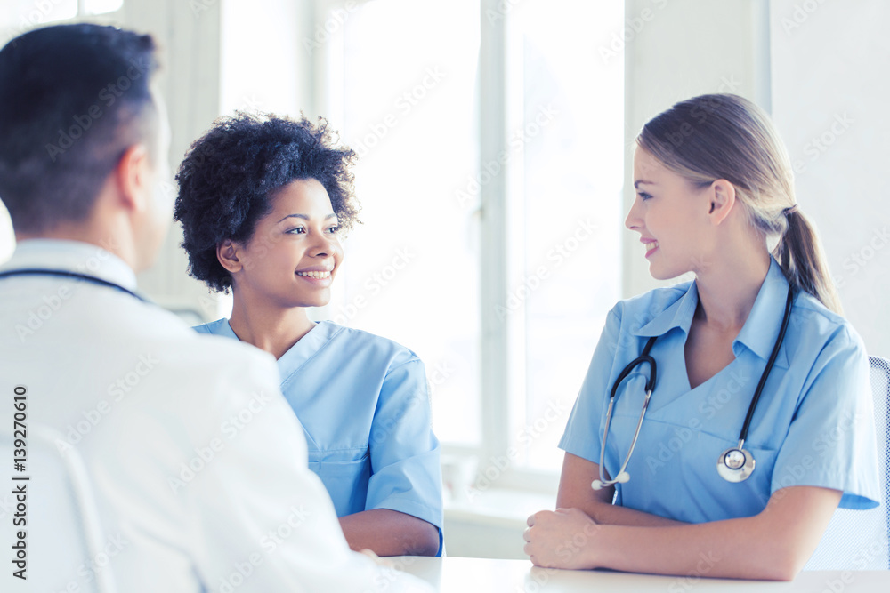 group of happy doctors meeting at hospital office group of happy doctors meeting at hospital office