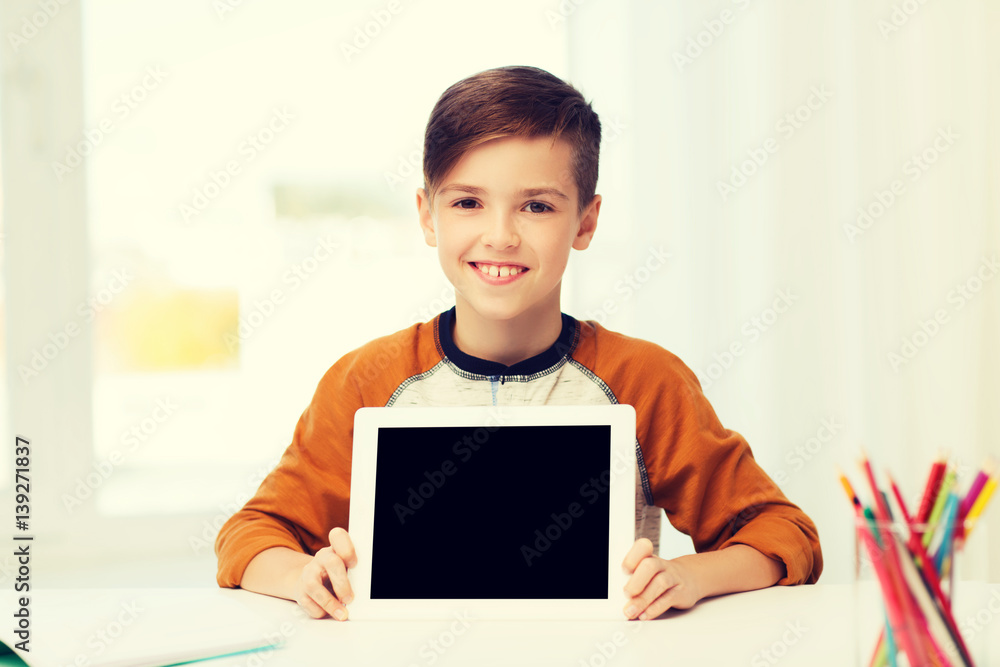 smiling boy showing tablet pc blank screen at home smiling boy showing tablet pc blank screen at home