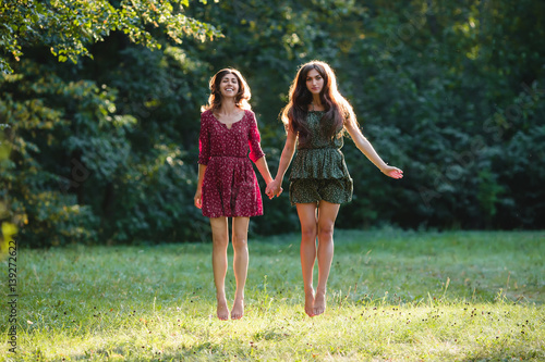 Fényképezés Two young smiling women levitate
