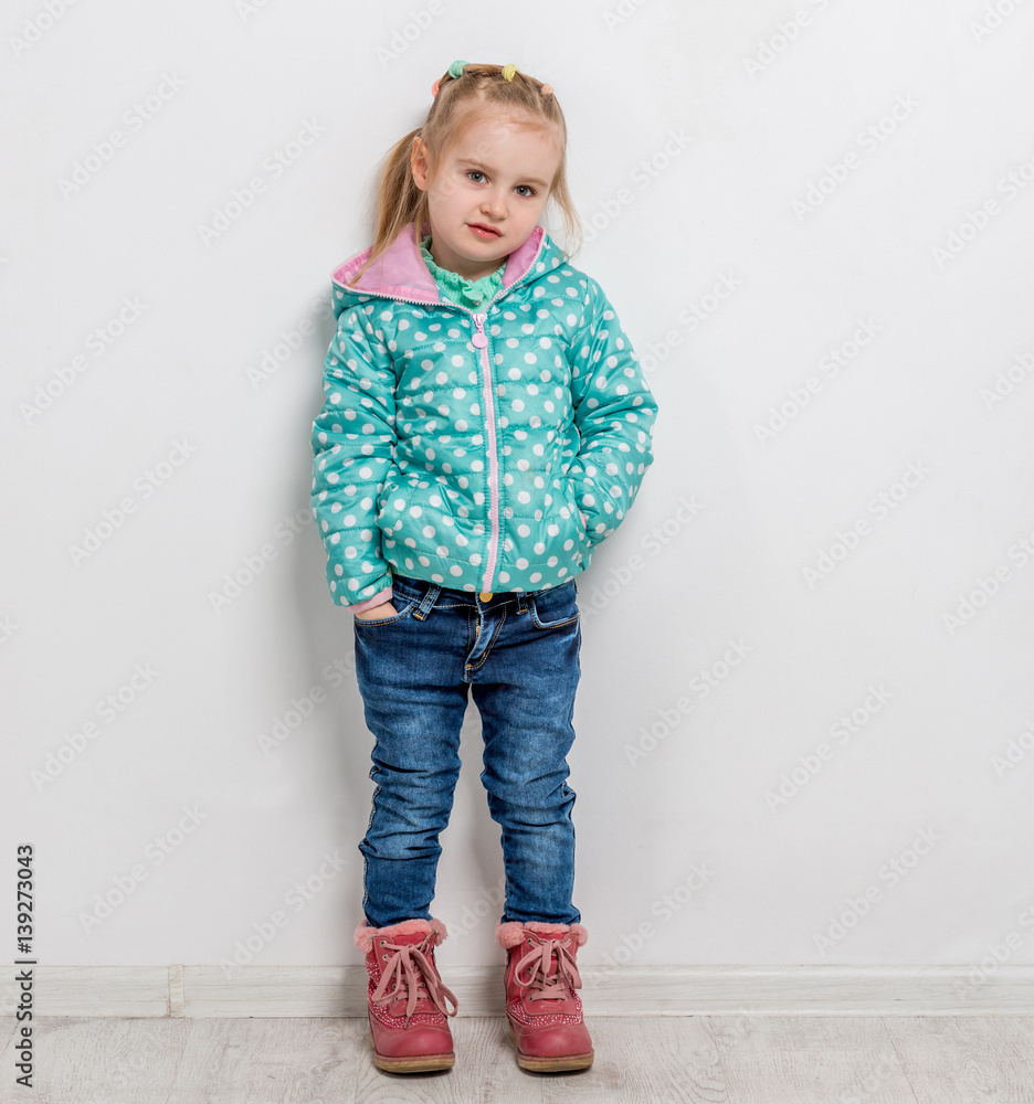 trendy little girl in jeans, jacket and boots trendy little girl in jeans, jacket and boots