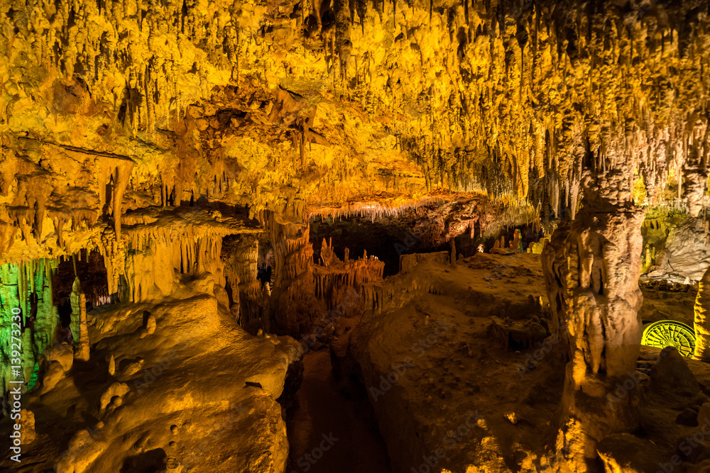 underground cave illuminated by colorful light