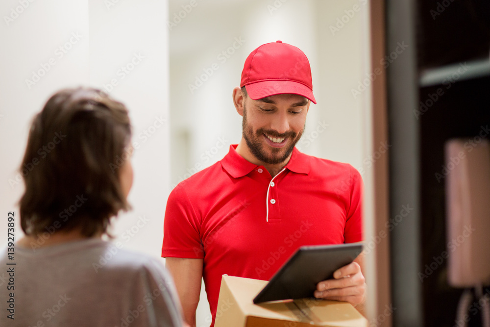 deliveryman with tablet pc and box at customer deliveryman with tablet pc and box at customer