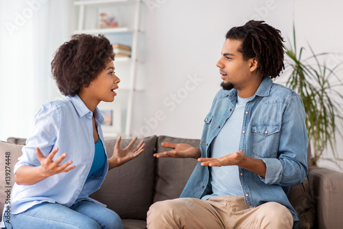 unhappy couple having argument at home