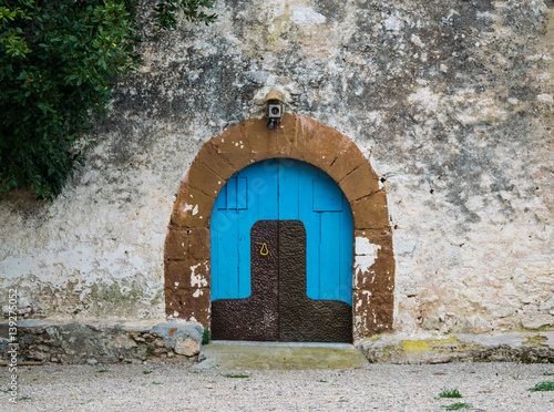 Blue wooden door in the old Spanish rural house photo