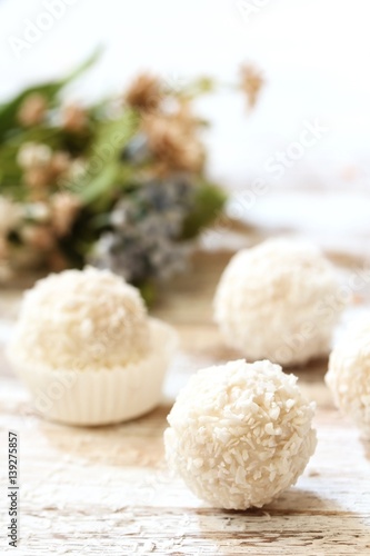 White Chocolate Coconut Truffles with spring flowers in background, selective focus