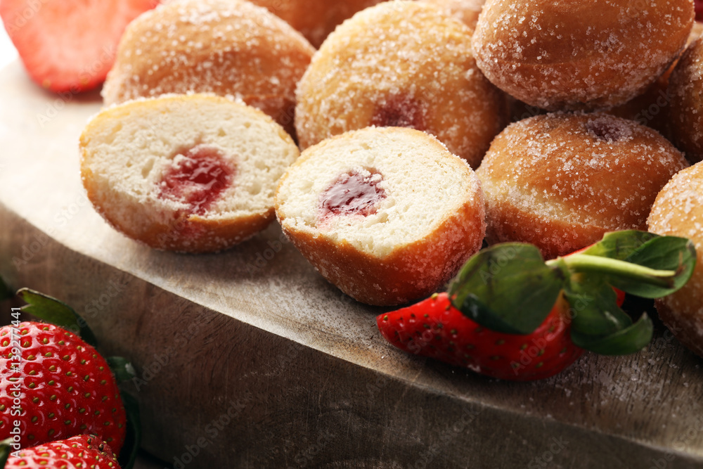 Bomboloni - traditional Italian doughnuts stuffed with strawberry jam