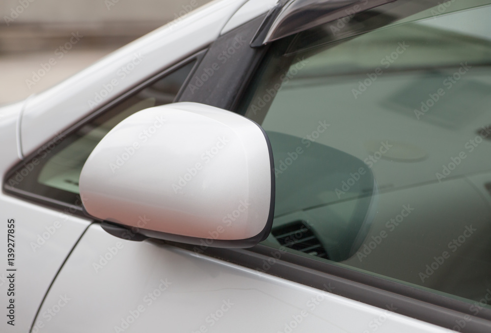 Side rear-view mirror closed for safety at car park. Side rear-view mirror closed for safety at car park.