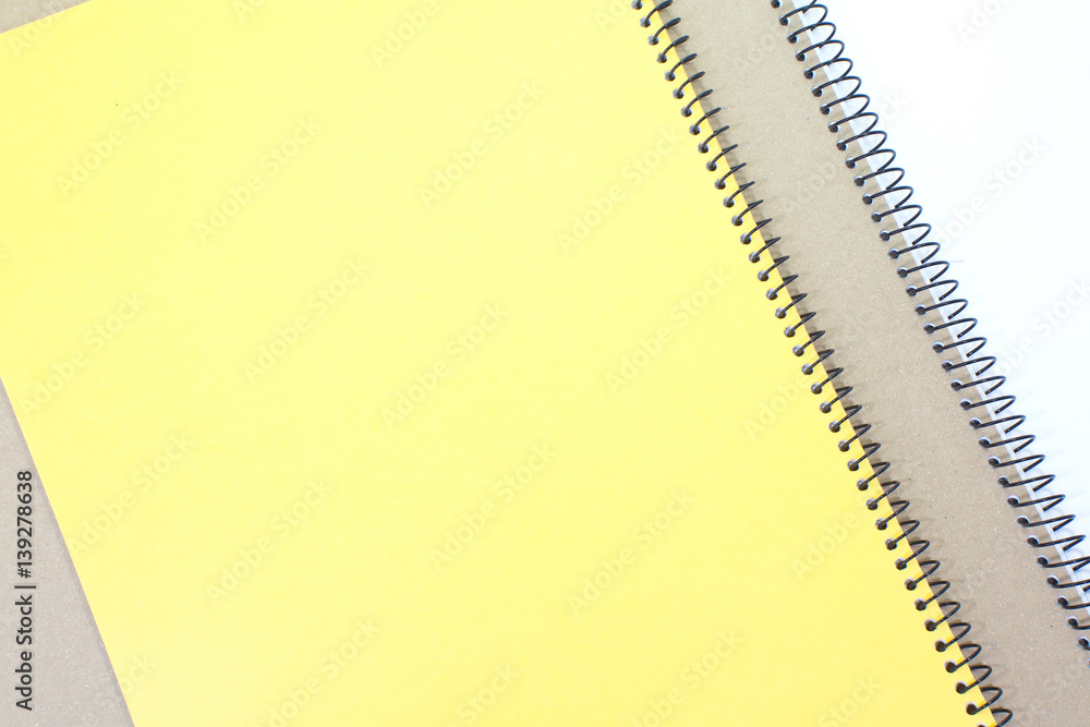 Yellow note book cover and brown note book on white background Yellow note book cover and brown note book on white background
