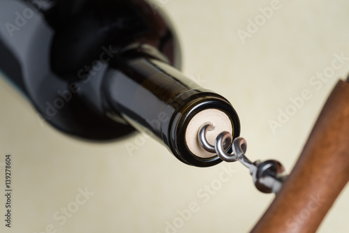 Removing the cork from a bottle of red wine