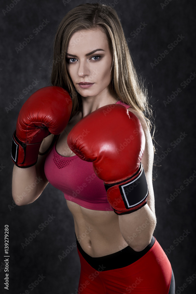 Pretty boxing woman in red box gloves