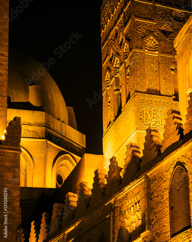 Arabic architecture on El-Moez Street in old town of Cairo - Mosque and Khanqah of al-Sultan al-Zahir Barquq. Landmarks of ancient muslim culture with arabesque and traditional ornaments on the walls. photo