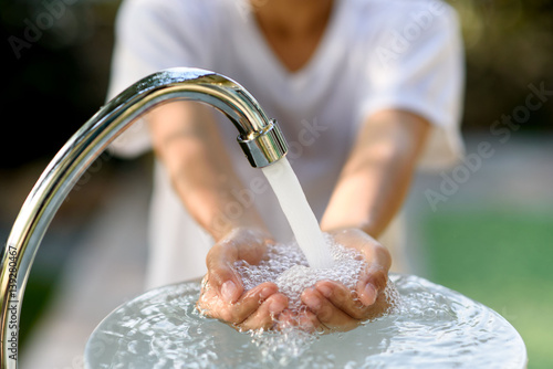 Faucet water and hand