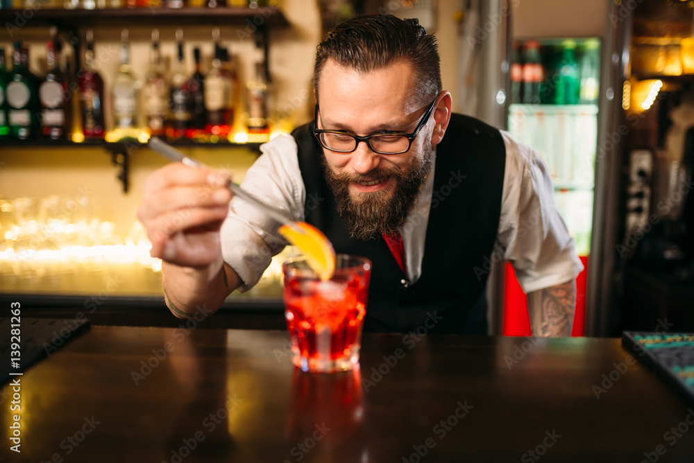 Bartender making alcohol coctail in restaurant