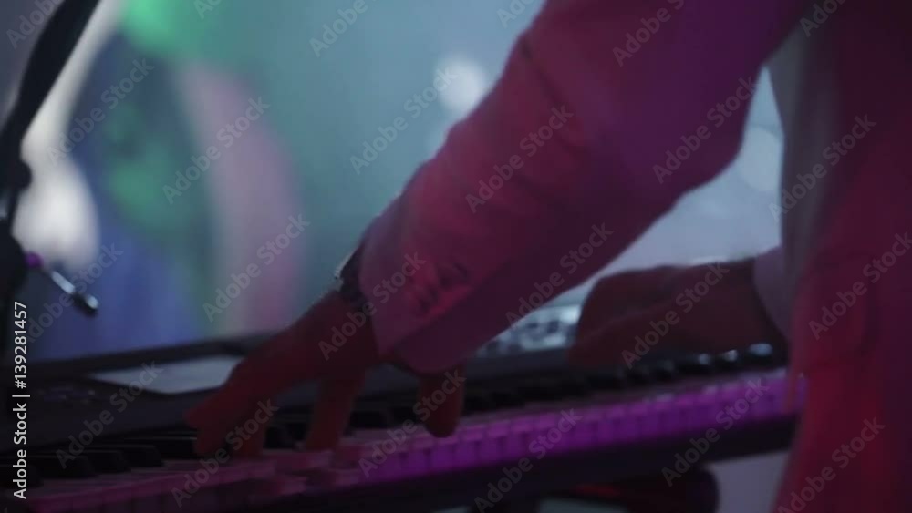 Man playing music on keyboard at concert Man playing music on keyboard at concert