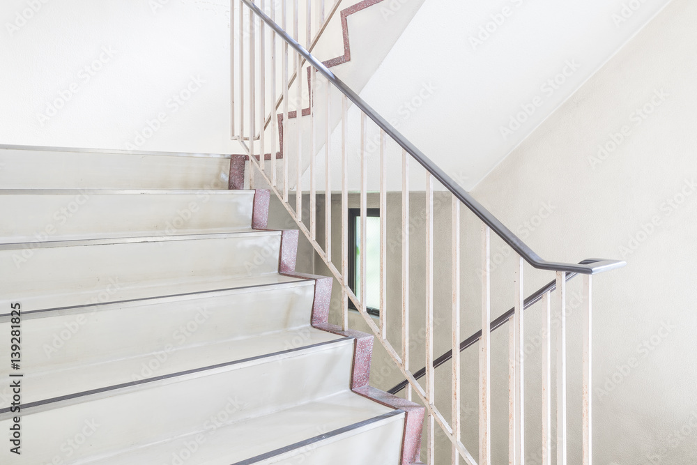 Fototapeta premium Concrete staircase with metallic handrail at modern buiding