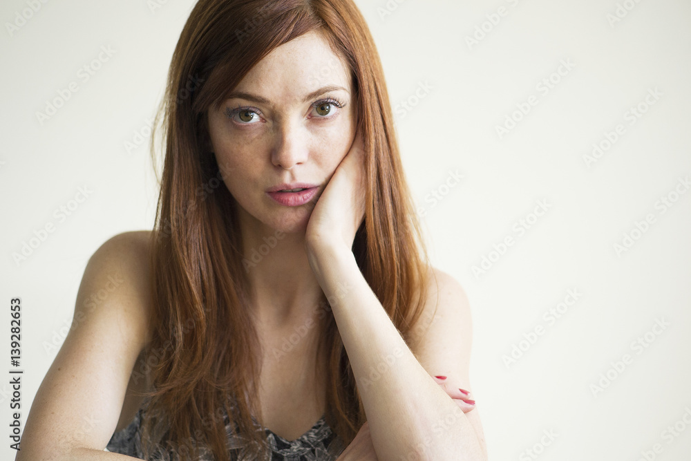 Portrait of a young woman against white background Portrait of a young woman against white background