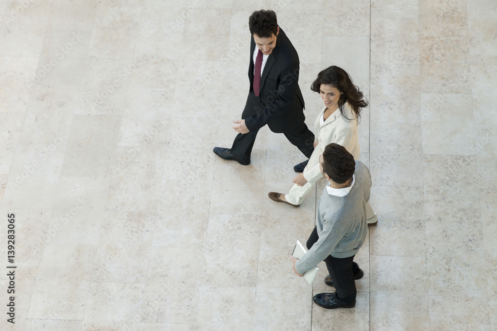 © PhotoAlto - Business people walking together in office lobby