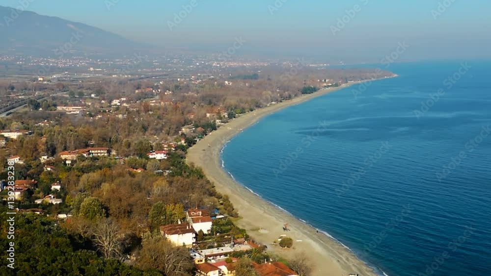 Pan left extreme long shot from turqoise blue sea and golden beaches to snow capped Mount Olumpus Pan left extreme long shot from turqoise blue sea and golden beaches to snow capped Mount Olumpus