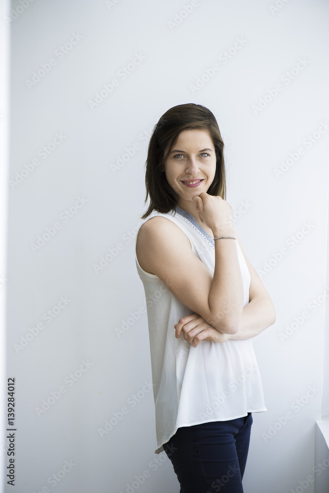 Woman with hand under chin, smiling cheerfully, portrait Woman with hand under chin, smiling cheerfully, portrait