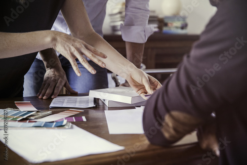 Designer showing color swatches to client, cropped