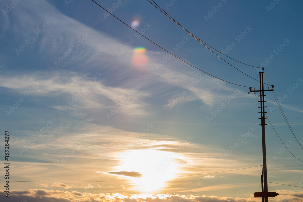 Close up of high voltage power lines on sunset background.