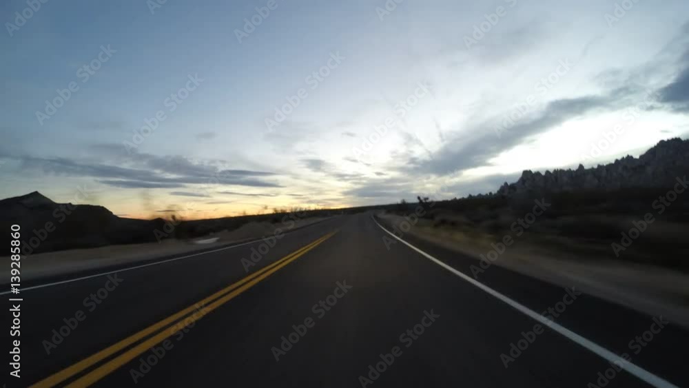 Desert twilight driving time lapse on Kelbaker Road through the Mojave National Preserve in Southern California. Desert twilight driving time lapse on Kelbaker Road through the Mojave National Preserve in Southern California.