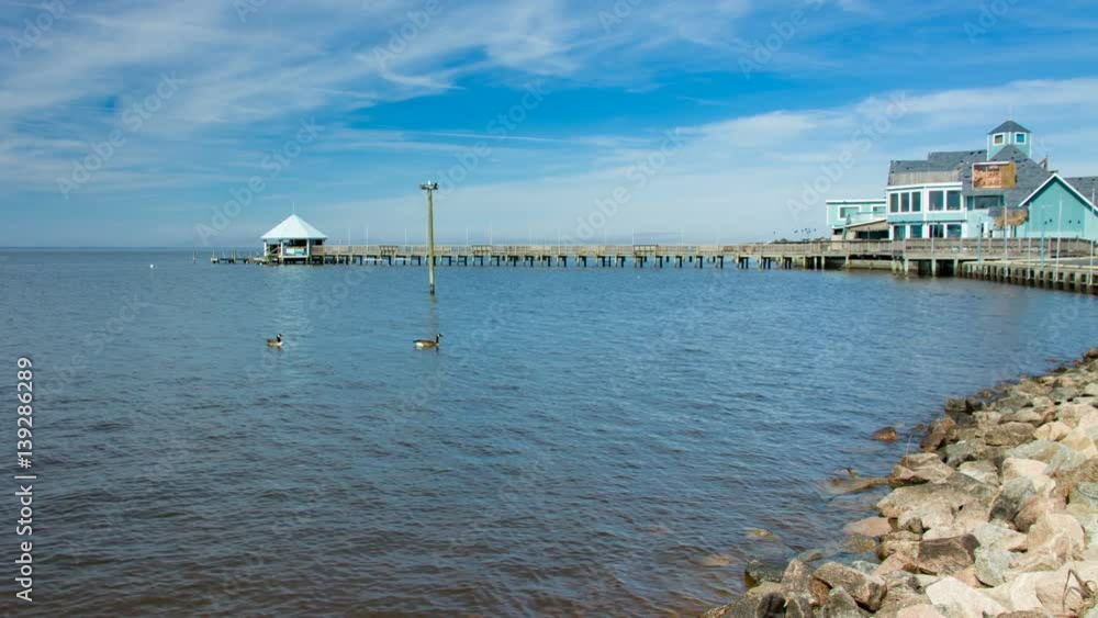 Currituck Sound Shores of Duck North Carolina with Local Restaurants and Bars Venue Pier Extending Over the Water Currituck Sound Shores of Duck North Carolina with Local Restaurants and Bars Venue Pier Extending Over the Water