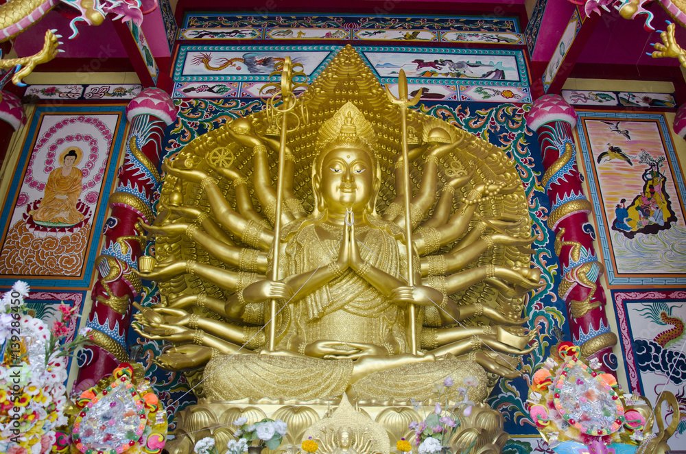 Guanyin bodhisattva and Thousand Hands statue in Chinese shrine for