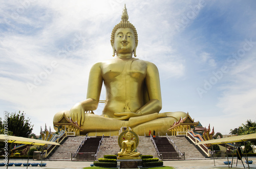 Thai people and travelers foreigner visit and pray golden biggest Shakyamuni buddha statue at Wat Muang temple © tuayai