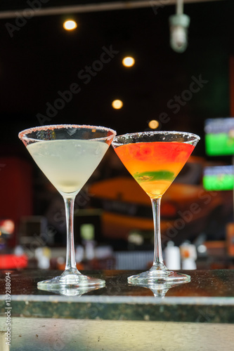 I count on some cocktails in a bar on a marble table on a black restaurant background.