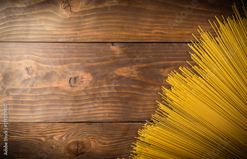 spaghettii on wood background top view