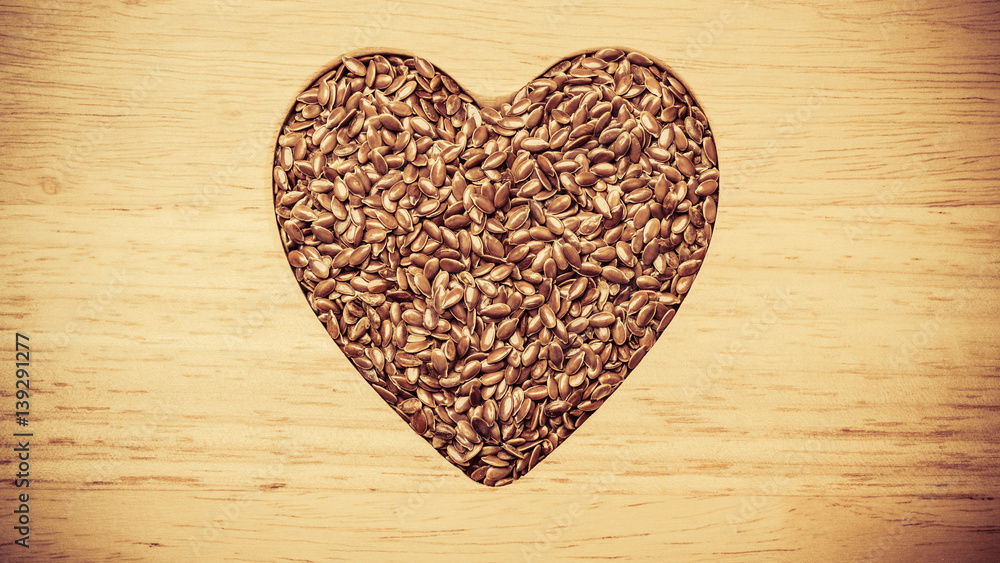 Raw flax seeds linseed heart shaped Raw flax seeds linseed heart shaped