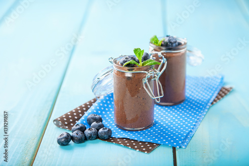 Chocolate and banana smoothie with seeds of a chia and blueberry. Selective focus. Copy space.