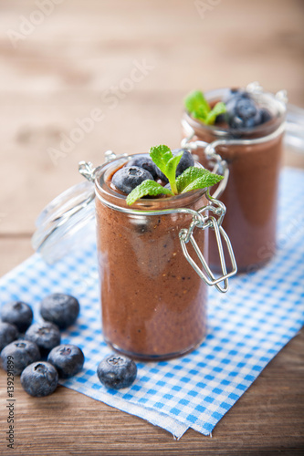 Chocolate and banana smoothie with seeds of a chia and blueberry. Selective focus. Copy space.