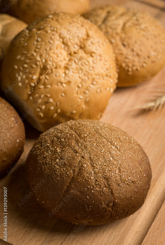 Tasty fresh buns on the wooden background Tasty fresh buns on the wooden background