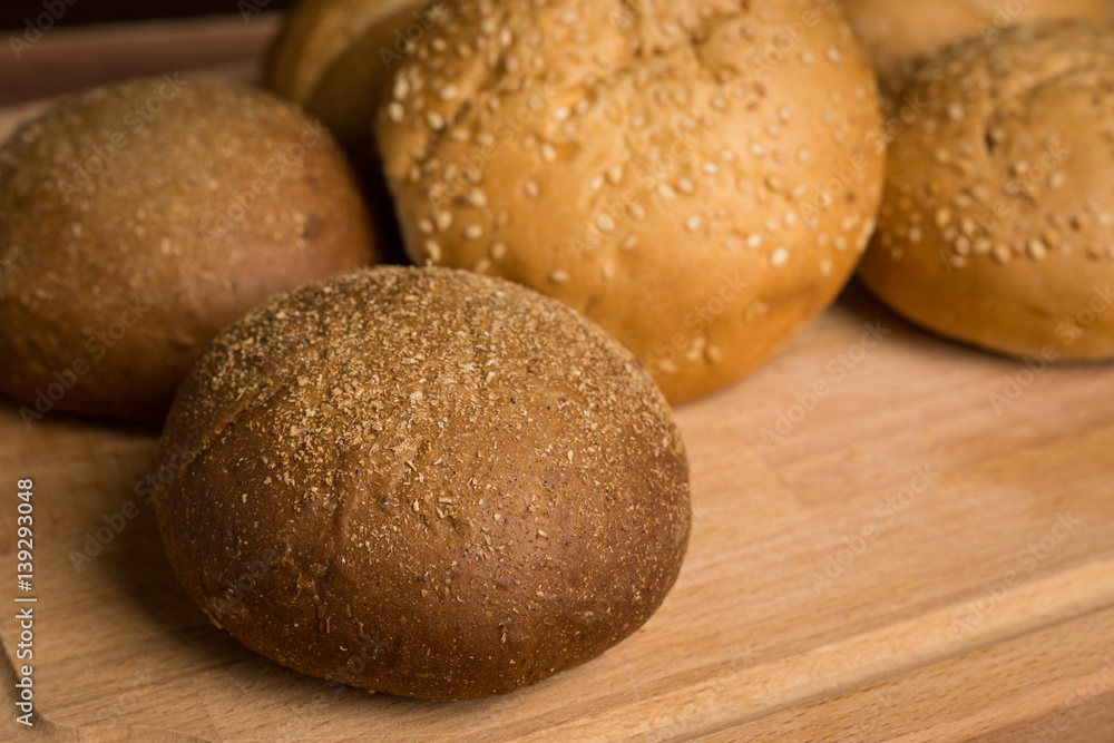 Tasty fresh buns on the wooden background Tasty fresh buns on the wooden background