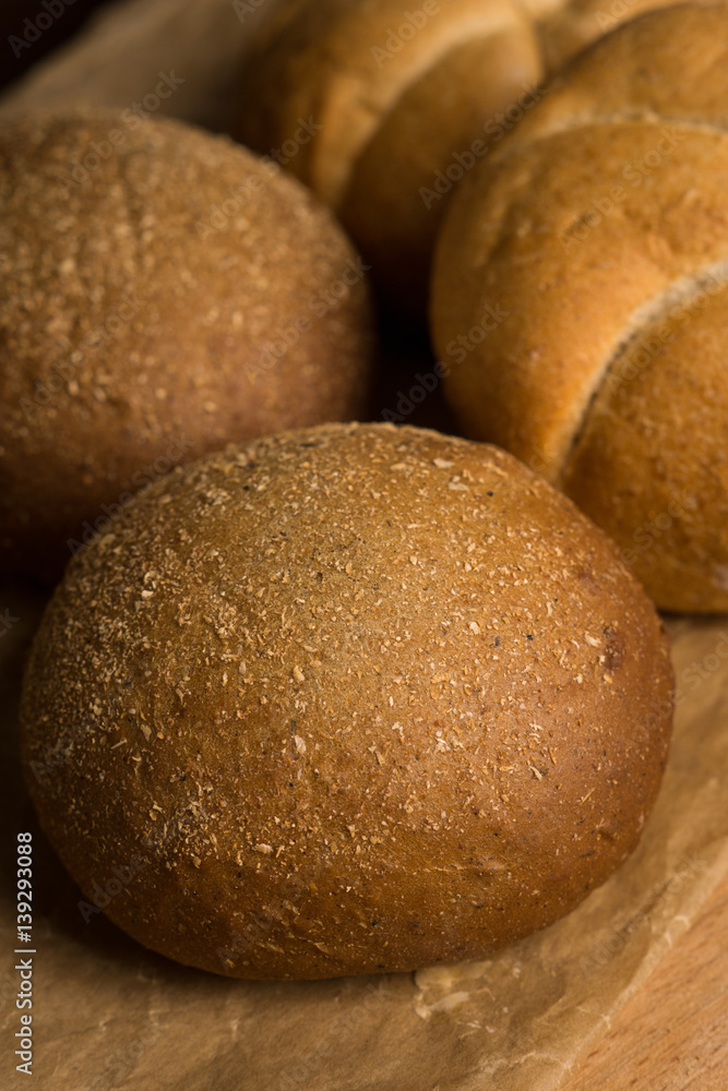 Tasty fresh buns on the wooden background Tasty fresh buns on the wooden background