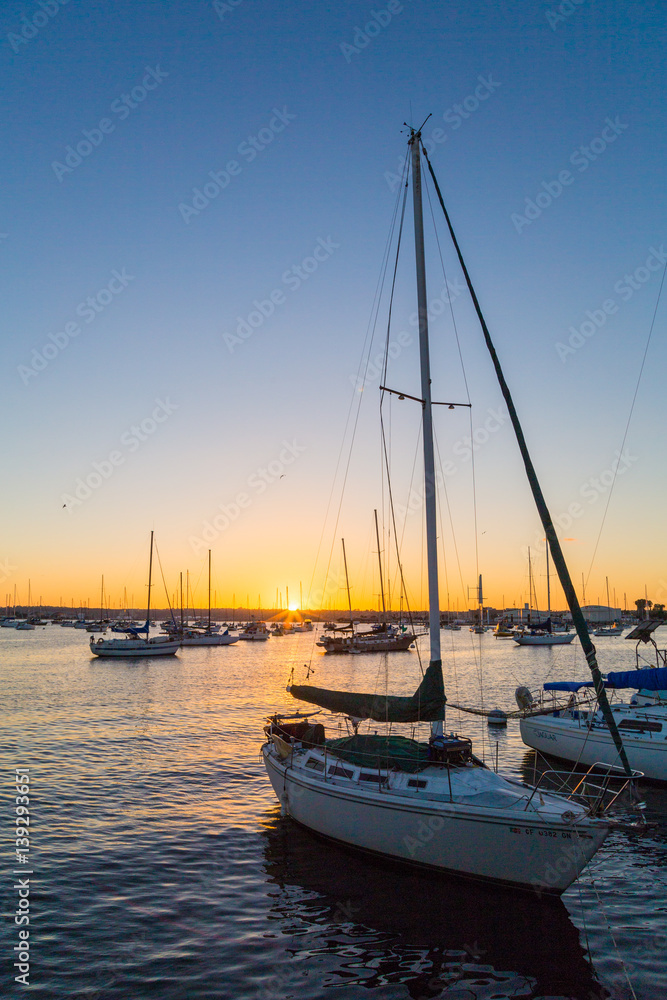 Sunset in marina. Sailboat, boat. Orange sky. San Diego. California