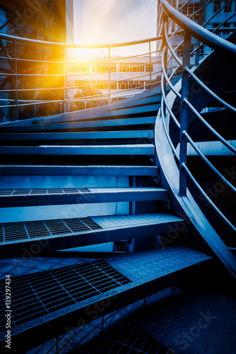Fototapeta Naklejka Na Ścianę i Meble -  low angle view of Spiral Staircase in blue tone.