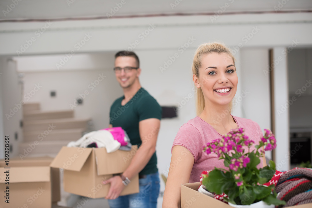 young couple moving into a new home young couple moving into a new home