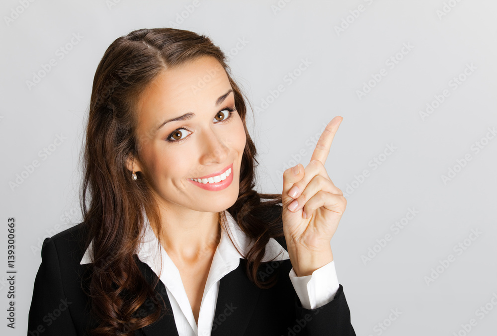 Business woman showing blank area for sign or copyspase, over gr Business woman showing blank area for sign or copyspase, over gr