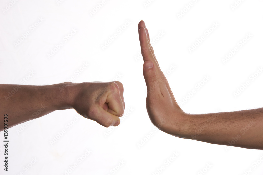 One hand preventing punch attack of another hand on isolate white background.