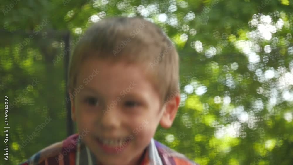 cute little child in a plaid shirt jumping on a trampoline slow motion cute little child in a plaid shirt jumping on a trampoline slow motion