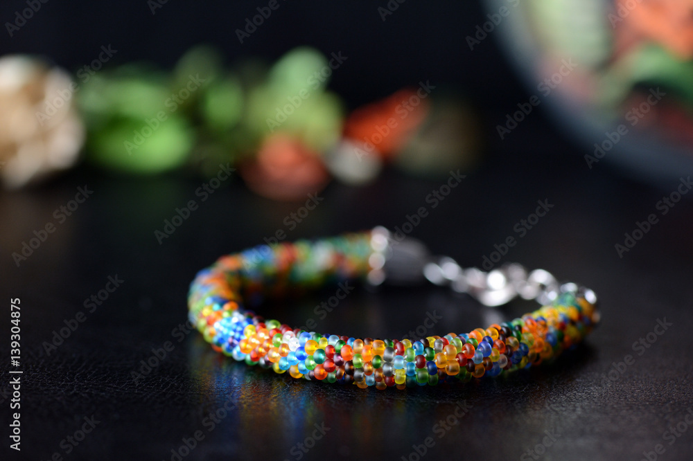Colorful bead bracelet on a dark background Colorful bead bracelet on a dark background