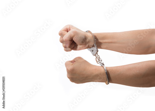 hands with tight fists on handcuff reaching out on white background